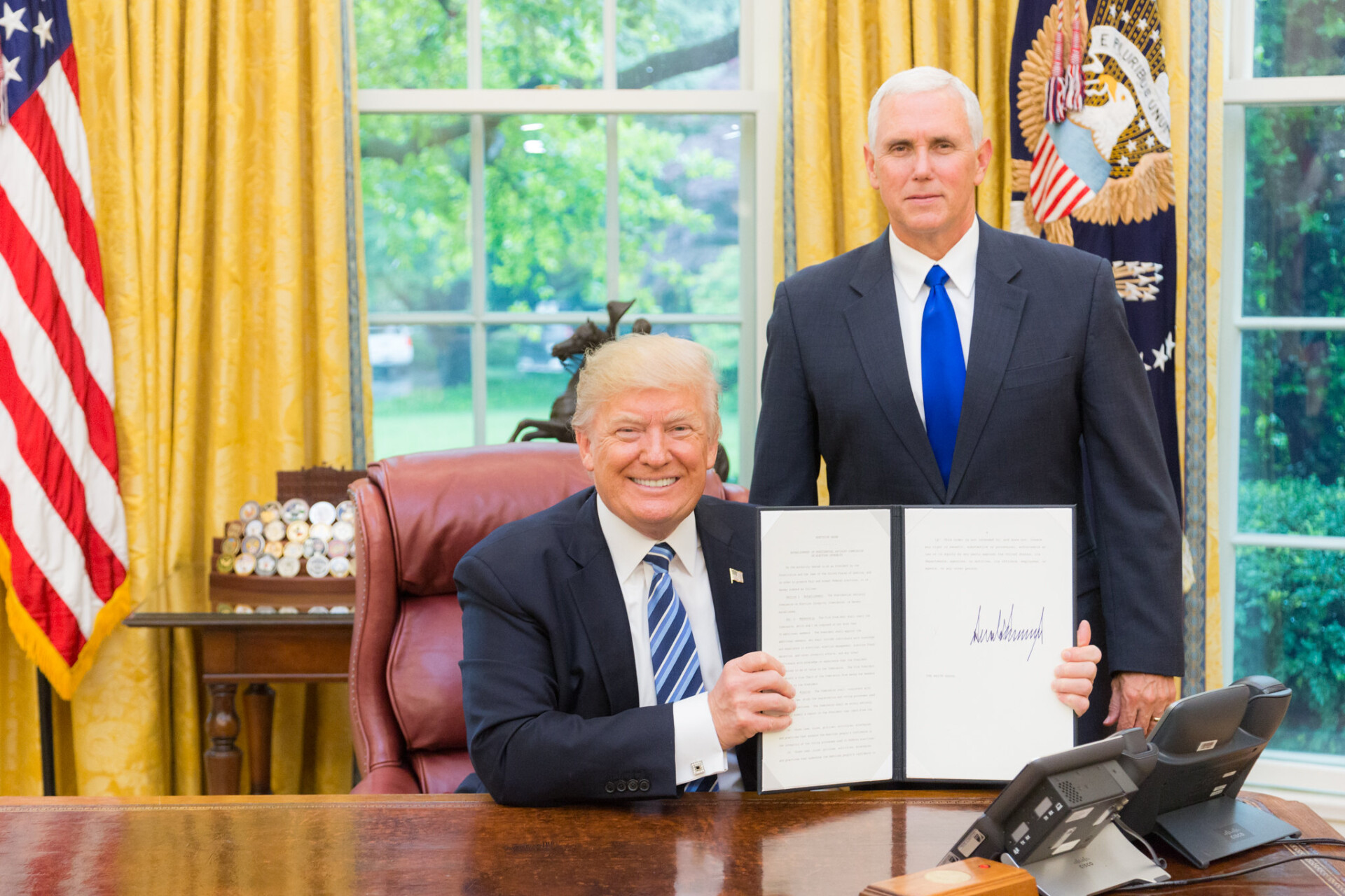"President Trump is joined by Vice President Pence for an Executive Order signing" by The White House is marked with Public Domain Mark 1.0.